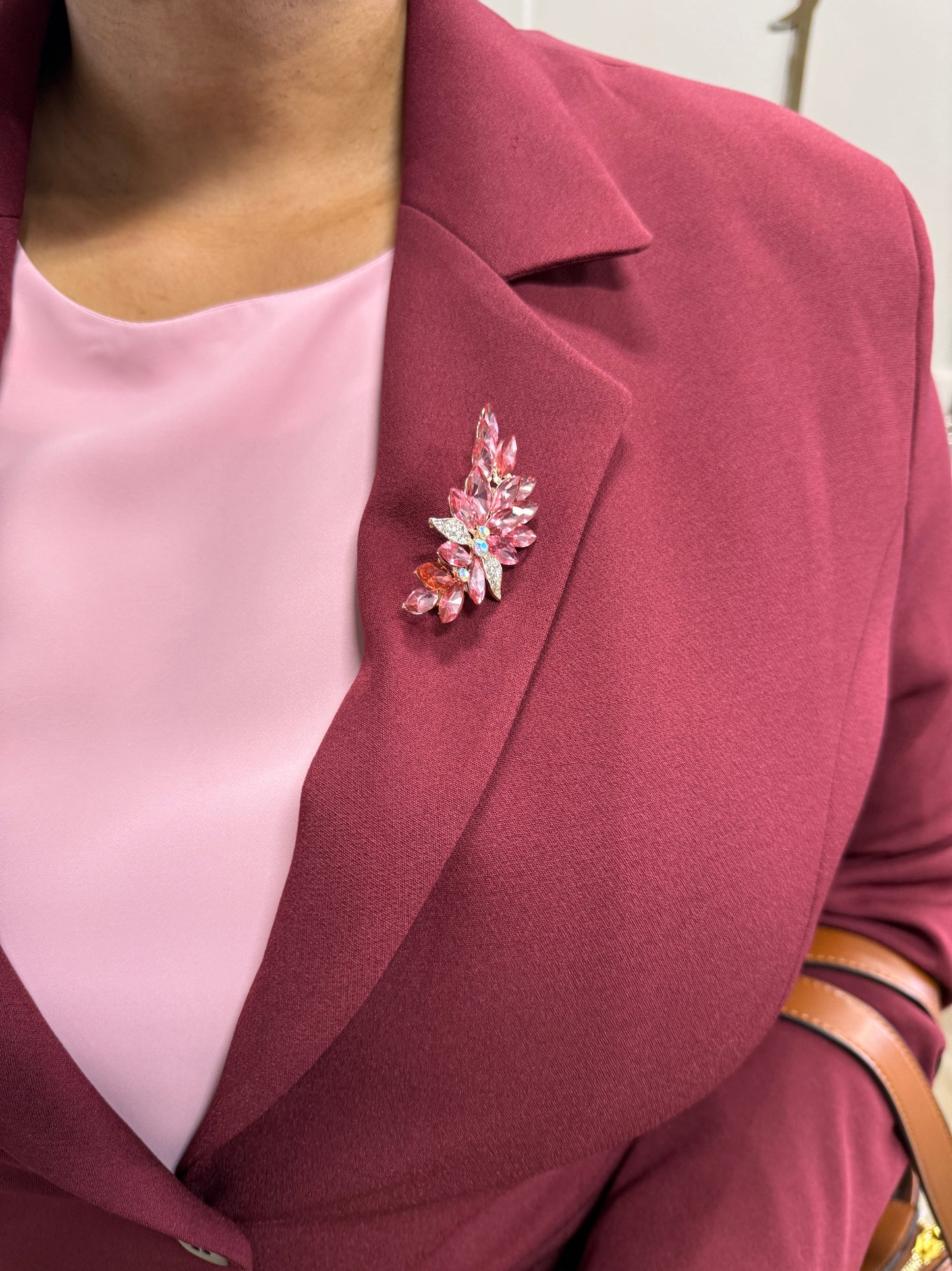Burgundy pant suit — close-up of lapel with pink crystal floral brooch